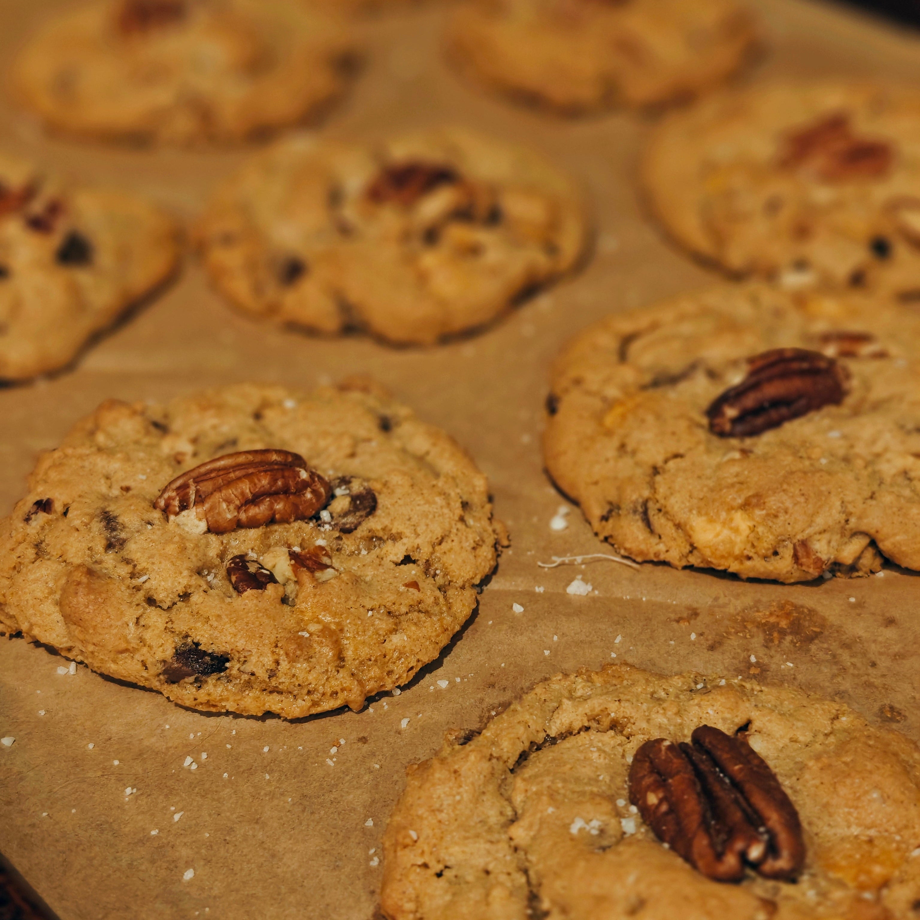 Baked cookies with pecans on a baking sheet