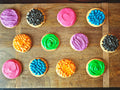 Colorful cookies with various patterns on a wooden board