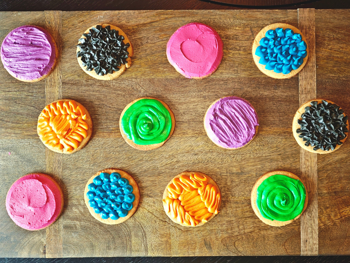 Colorful cookies with various patterns on a wooden board