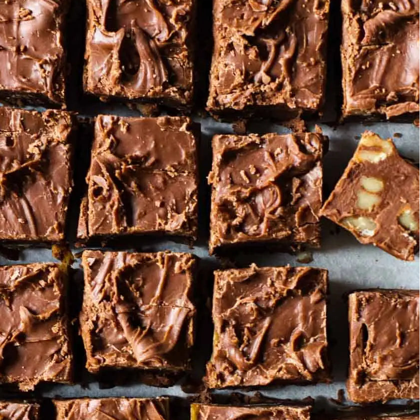 Chocolate fudge squares arranged in a grid on a white surface